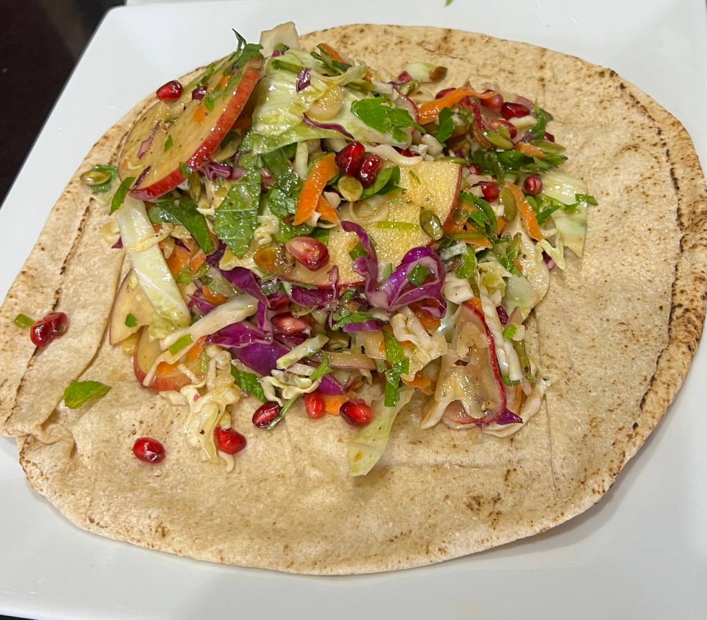 Cabbage, apple, and pomegranate slaw with cumin&nbsp;dressing