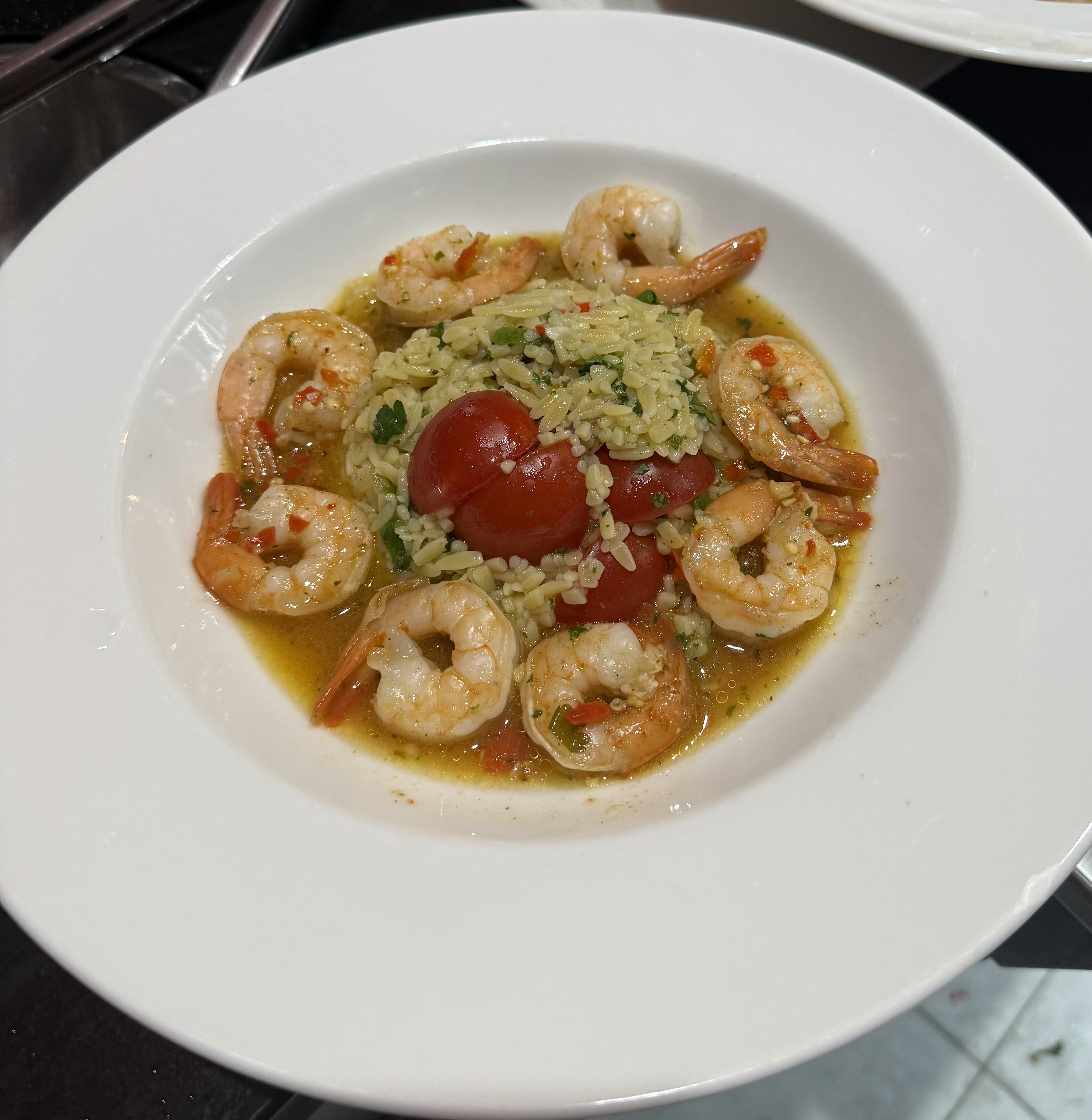 Prawns in chilli butter with risoni and herb salad
