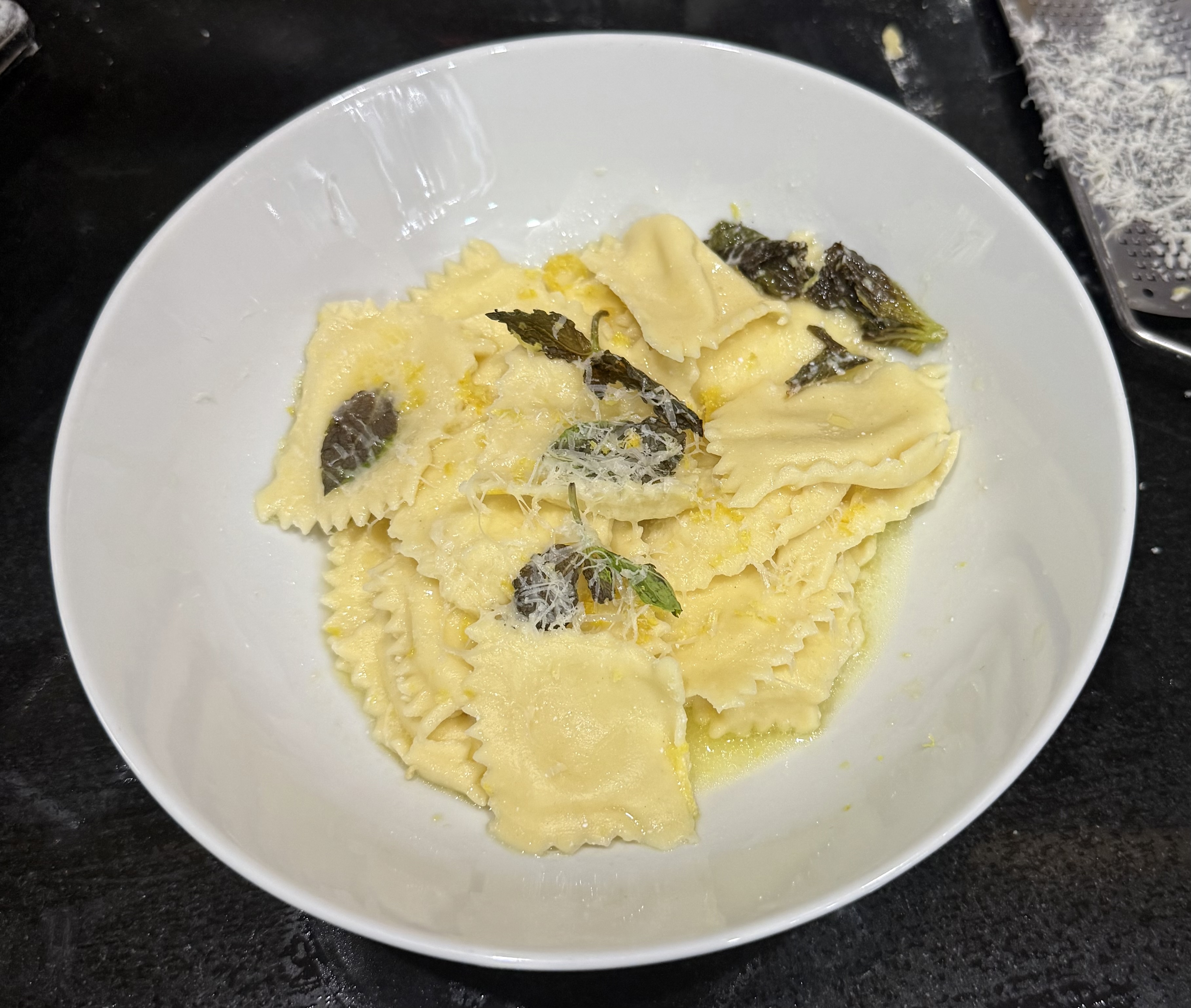 *Ravioli ripieni di ricotta e limone con salsa di burro e menta (Ravioli filled with ricotta and lemon, served with butter and mint)